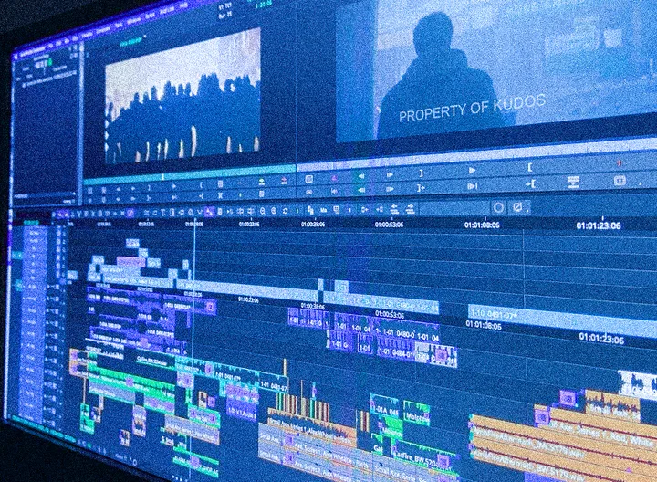 A video editing timeline on a large monitor